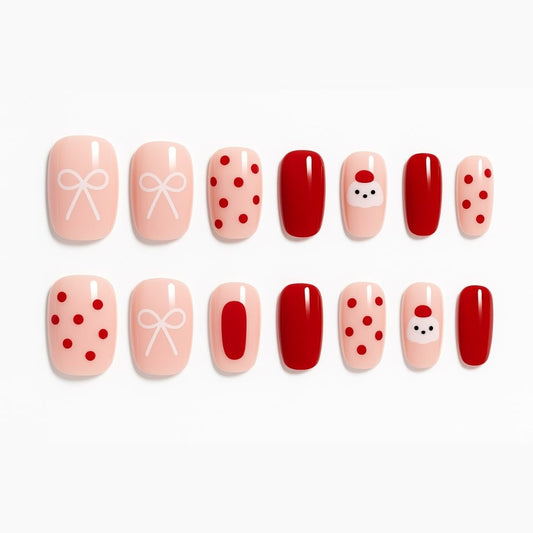 Festive Red & Nude Press-On Nails – Santa, Bow & Polka Dot Design.